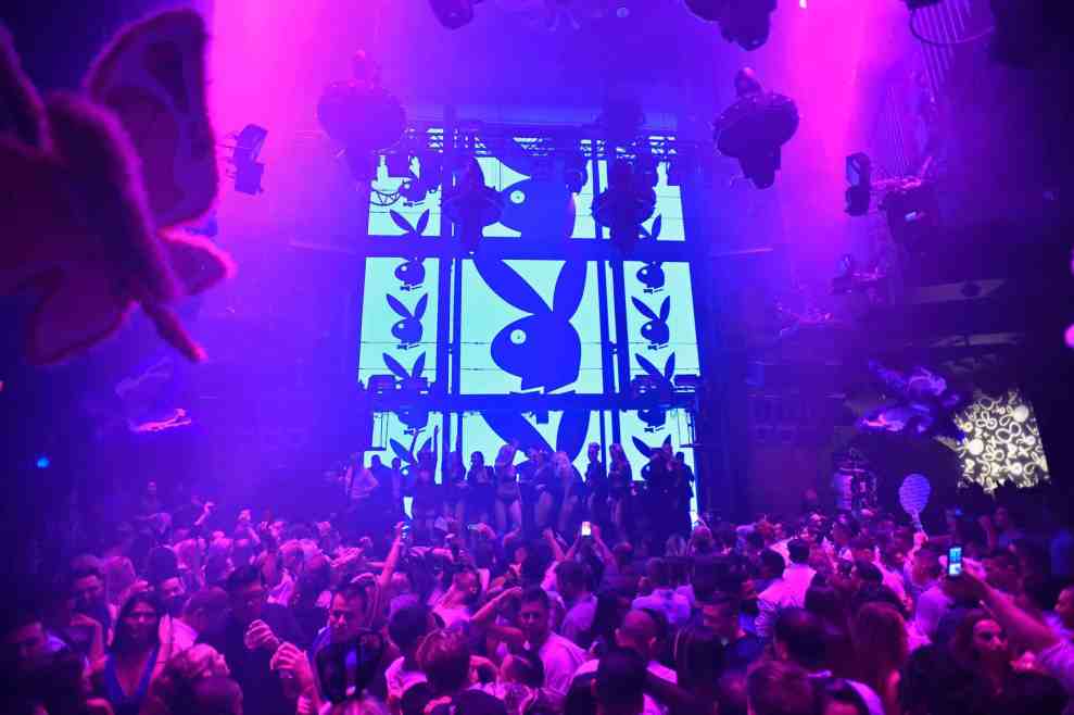 Playboy bunny logo behind crowd