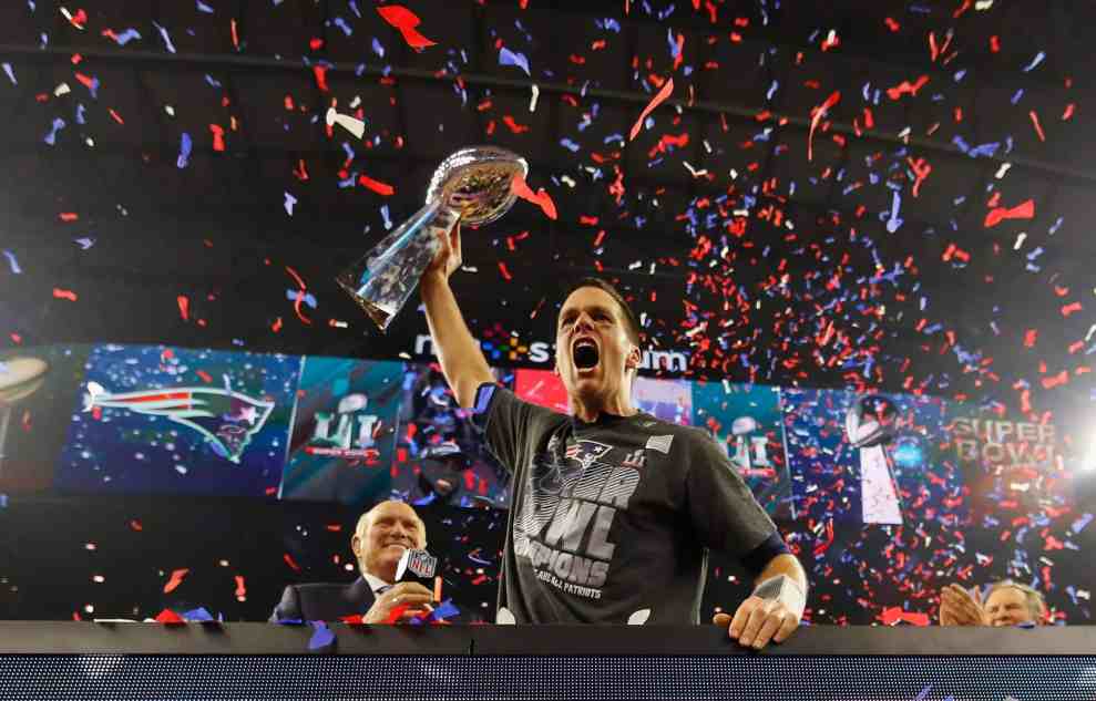 Tom Brady holding Lombardi trophy on field after Super bowl 51 win