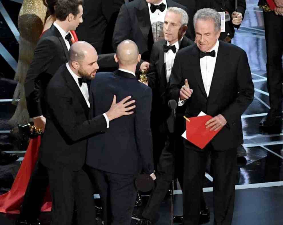 Warren Beatty with red envelope at Oscars where he announced the wrong winner of best picture
