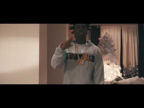 Kodak Black in front of white christmas tree