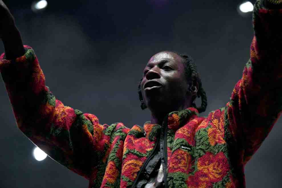 Joey Bada$$ performing in multicolored jacket