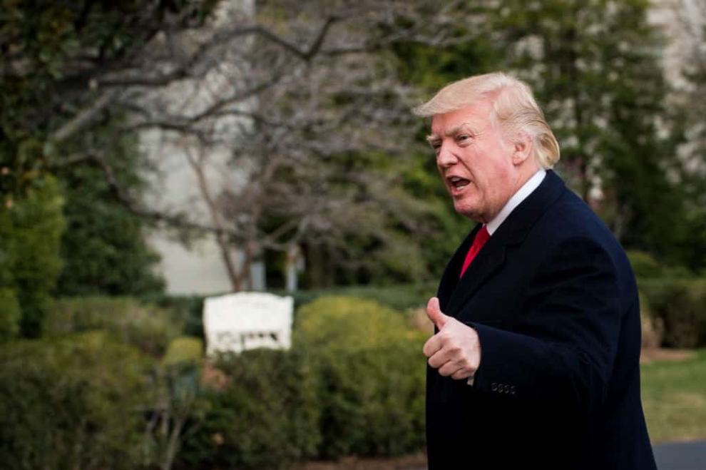 Donald Trump walking and giving a thumbs up on whitehouse grounds