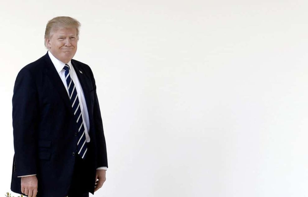 Donald Trump on left third of photo in front of white background