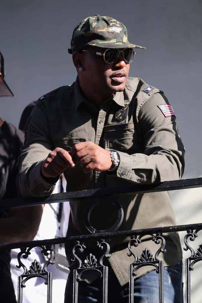 Cam'ron leaning over railing