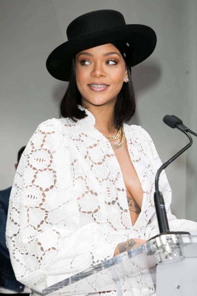 Rihanna wearing all white lace Dior dress and black hat at  LVMH Young Fashion Designer’s 2017 prize awards