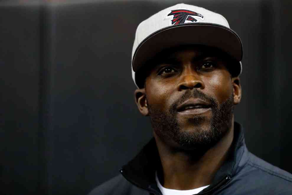 Michael Vick walks on the field prior to the game against the New Orleans Saints at the Georgia Dome on January 1