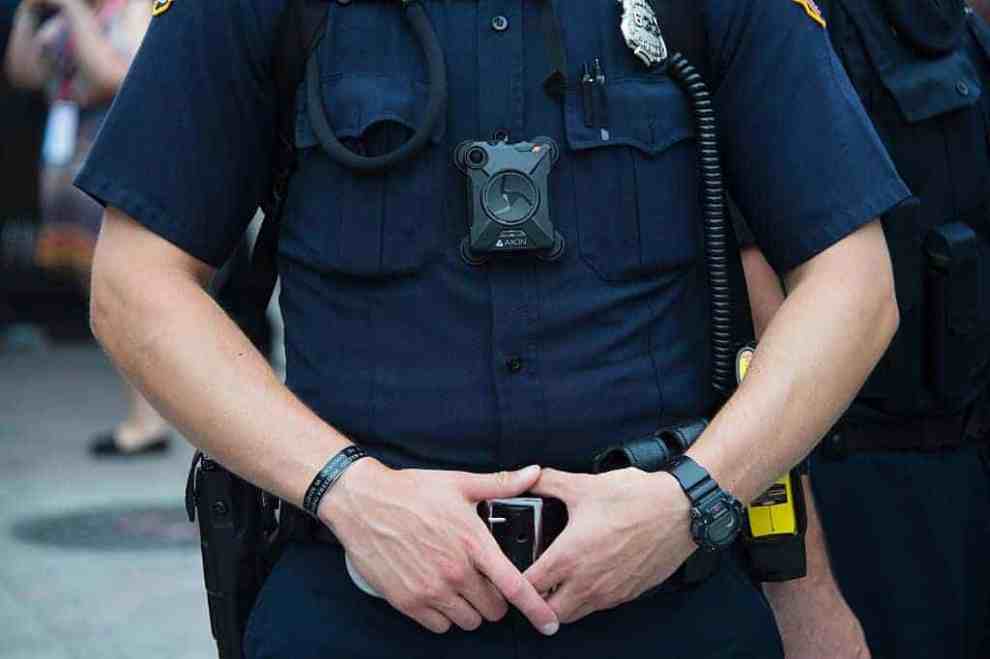 Police officer with hands on belt