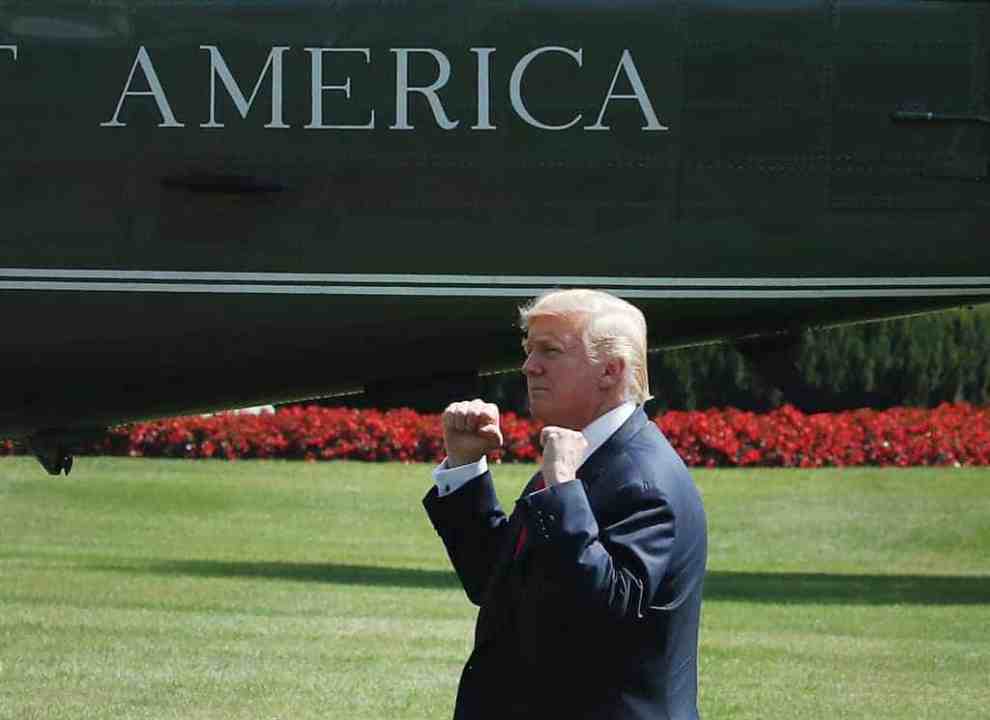 Donald Trump in front of Marine One Helicopter with both fists raised