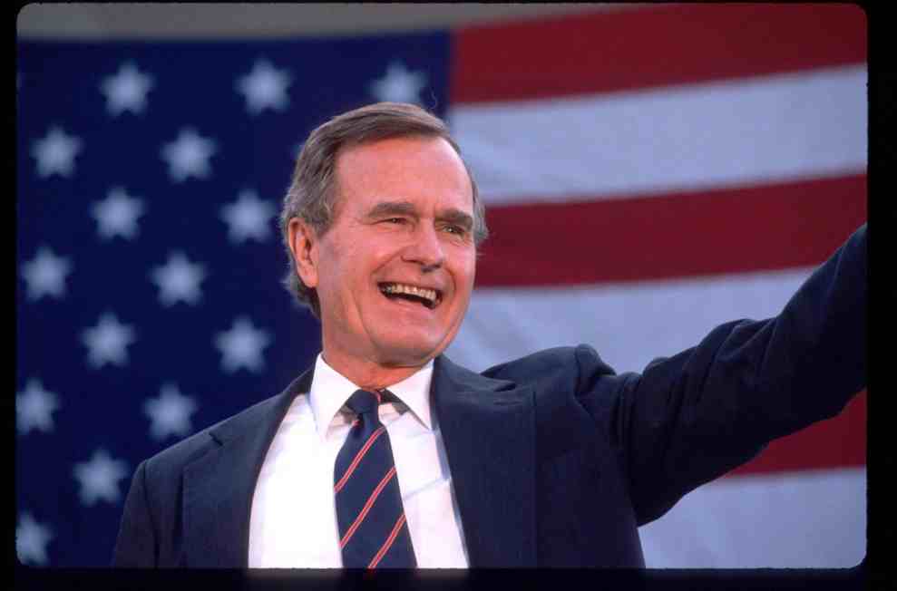 President George HW Bush waves to a crowd of supporters November 5