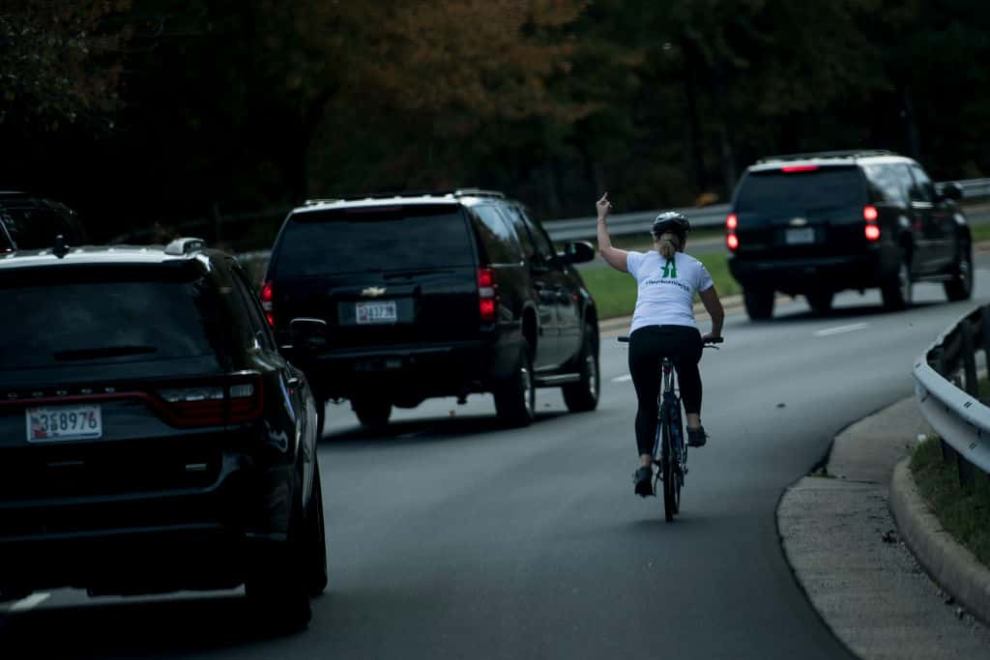Woman on bike giving the finger to cars