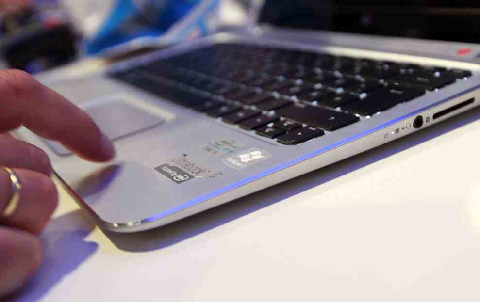 Unidentified man trys out a HP Spectre XT laptop computer featuring an Intel Ultrabook processor 2012