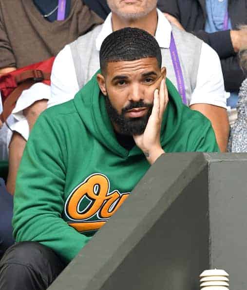 Drake attending game in green owl sweatshirt
