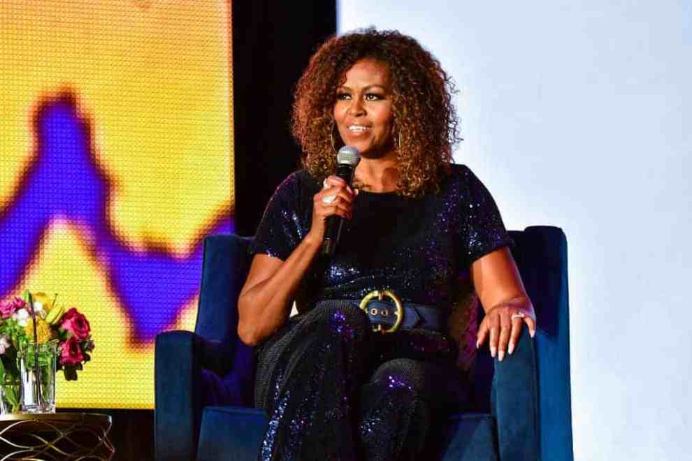 Michelle Obama on stage with a microphone