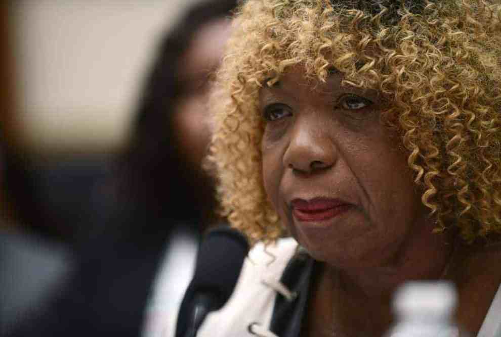 Gwen Carr sitting in front of a microphone