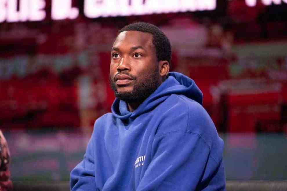Meek Mill wearing blue hoodie on stage
