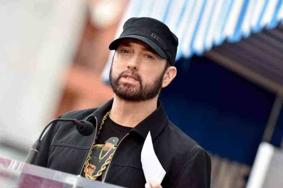 Eminem wearing a black hot and jacket