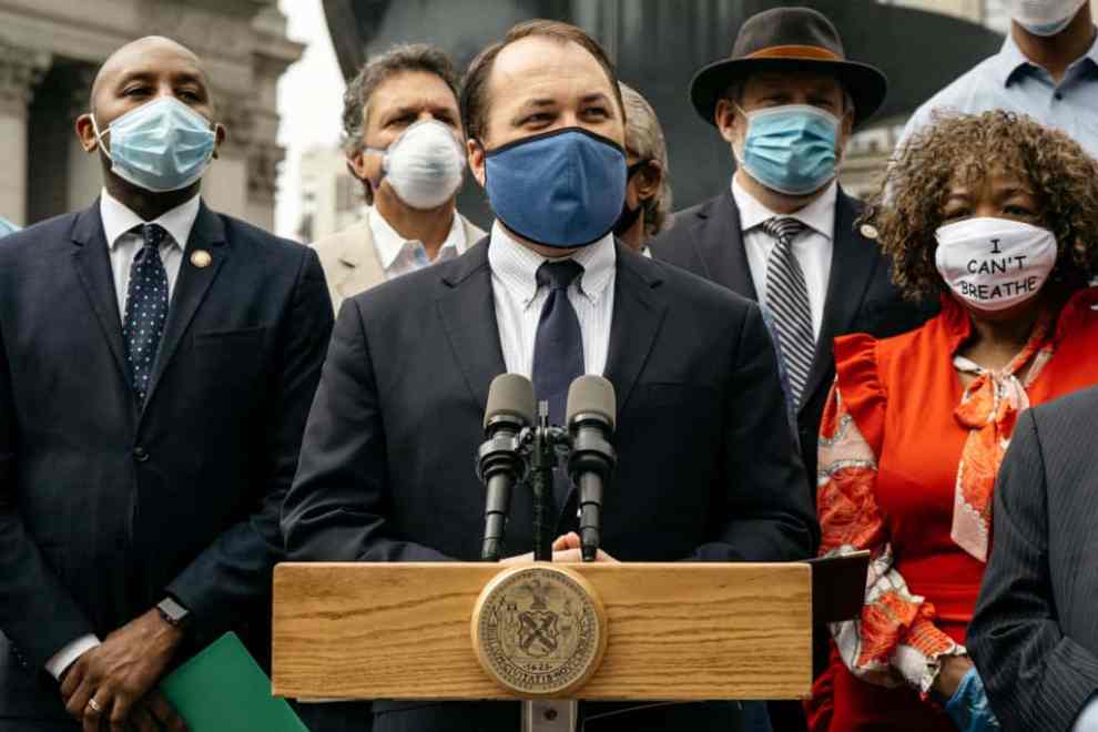 NYC Comptroller candidate Corey Johnson stand's with Eric Garner's mother at a press conference.