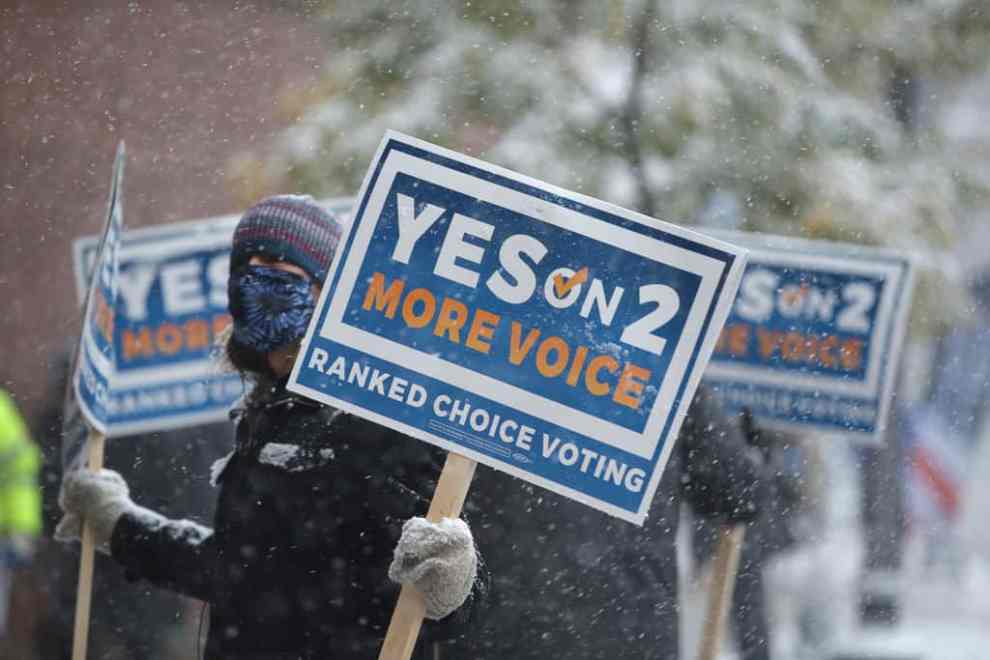 Signs of people campaigning for Ranked Choice Voting