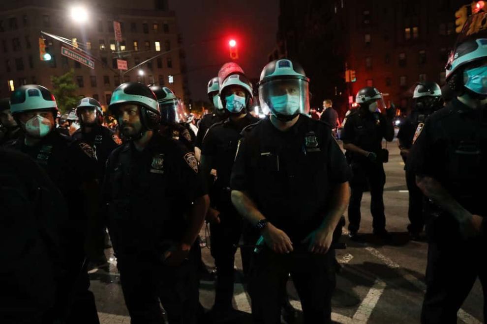 Police officers wearing shields of armor during the protest