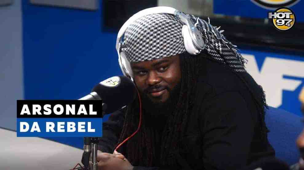 American Battle Rapper Arsonal With Headphones on at the microphone