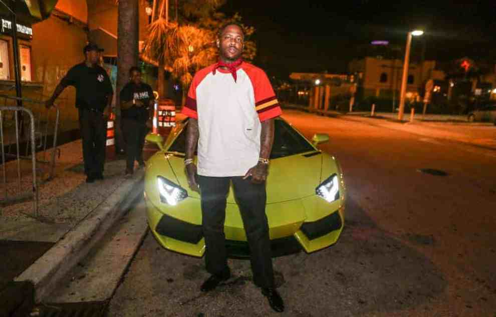 Image of YG in front of a car