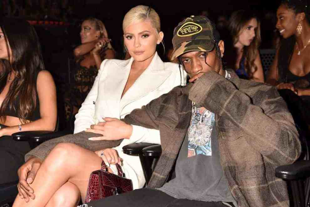 Kylie Jenner and Travis Scott looking at the camera wearing white and green camouflage