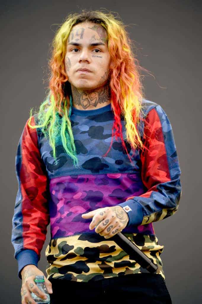 6ix9ine wearing a rainbow colored sweater