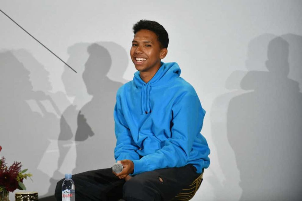 Tyler Mitchell wearing a blue hoodie