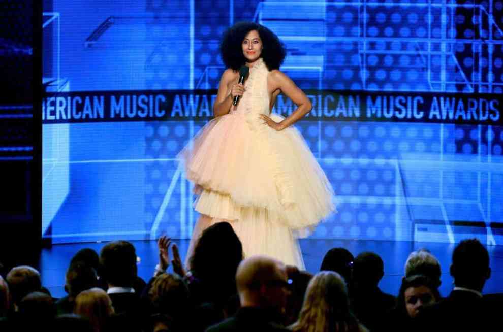 Tracee Ellis Ross wearing a creme tule dress while hosting on stage at the American Music Awards