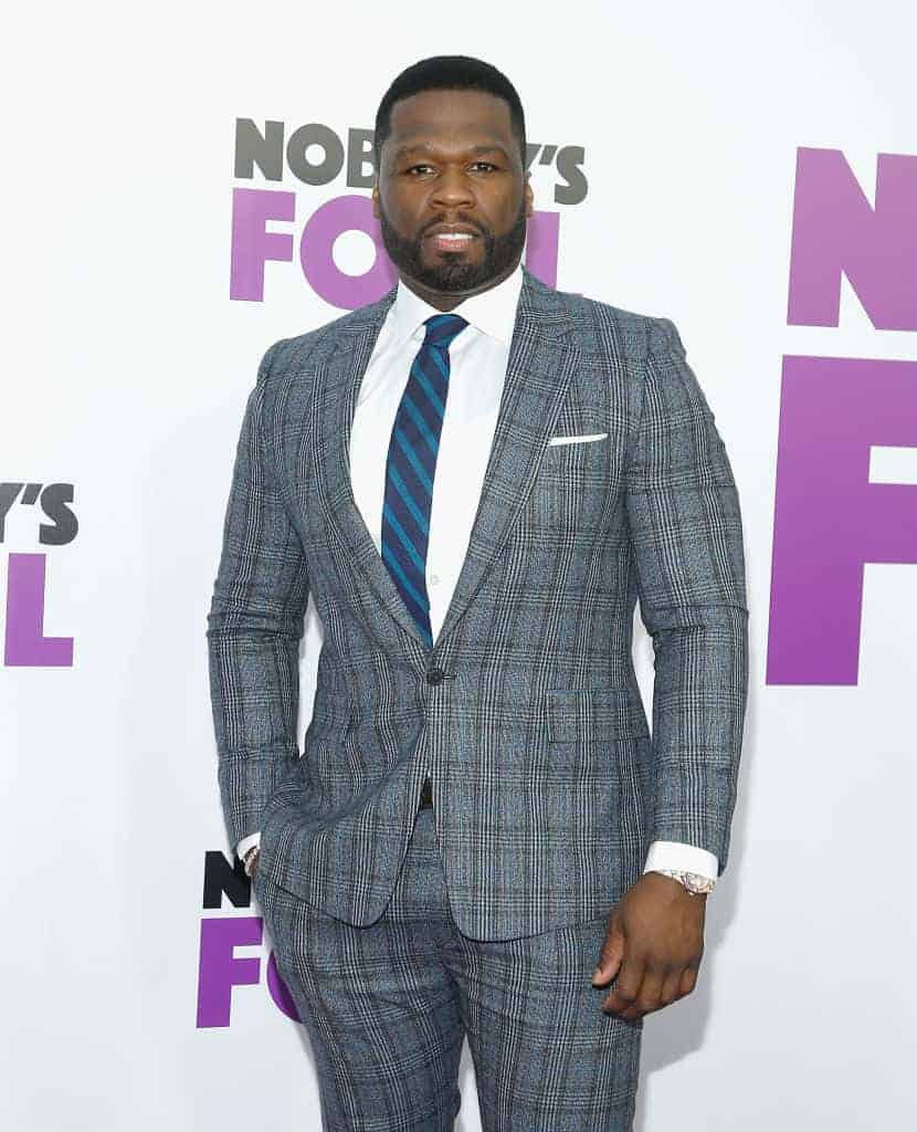 50 Cent wearing a grey suit