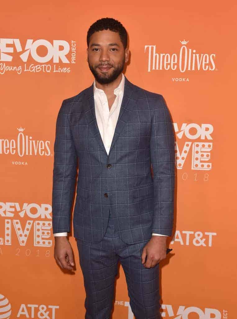Jussie Smollett wearing grey and white