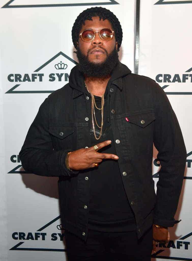 Big K.R.I.T wearing all black holding up the peace sign