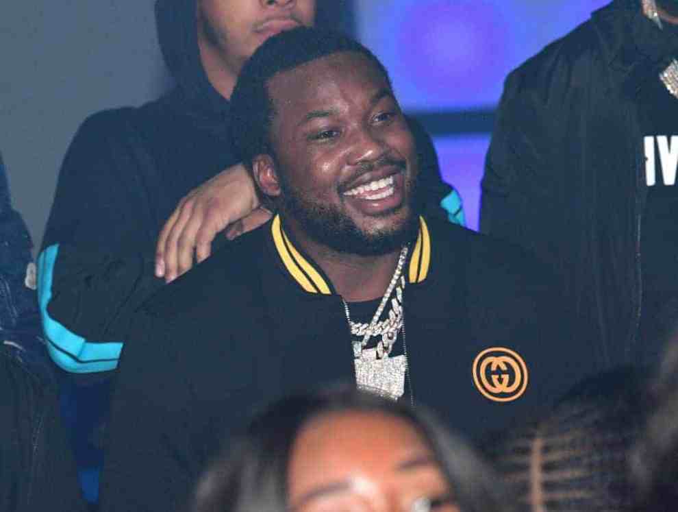 Meek Mill smiling while sitting in crowd