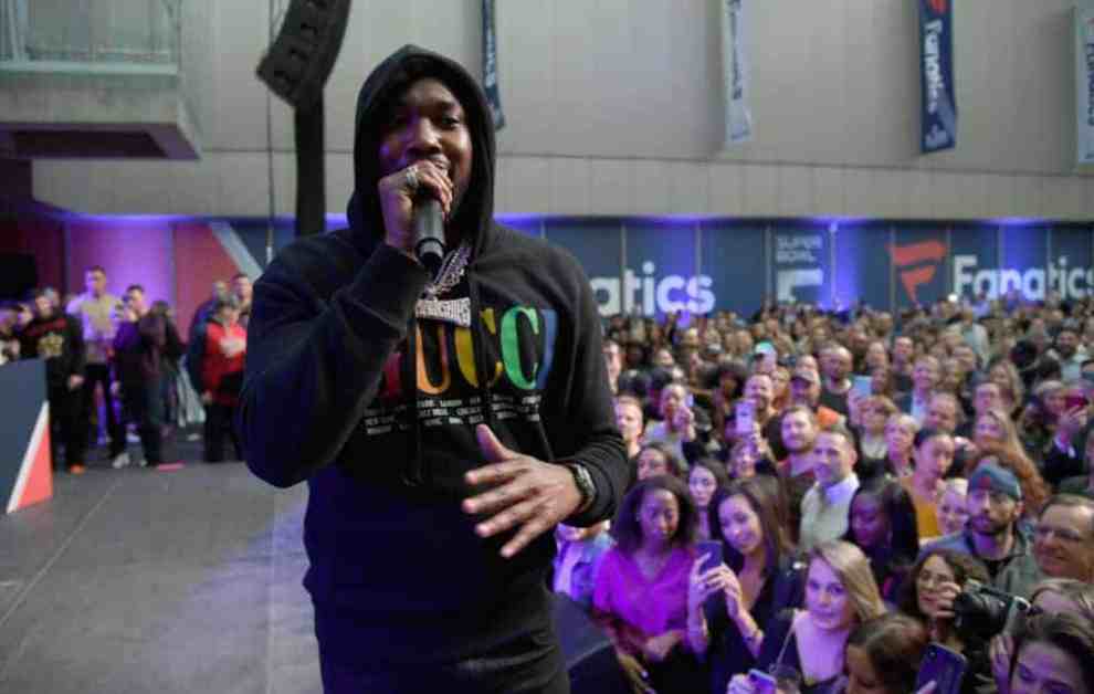 Meek Mill wearing a black hoodie on stage