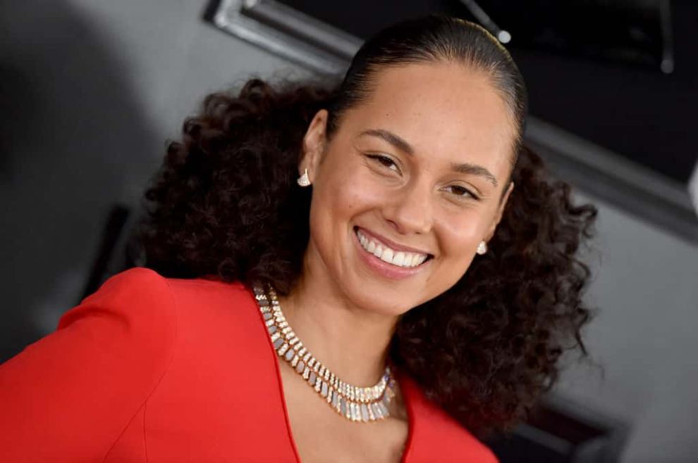 Alicia Keys wearing red dress smiling at camera