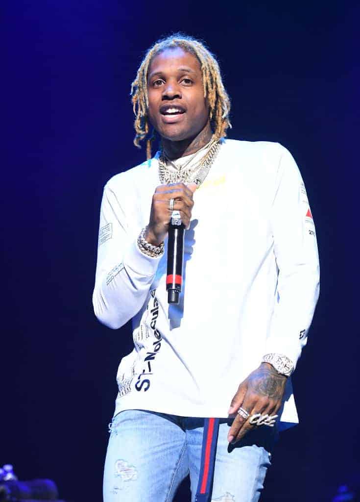 Lil Durk wearing a watch shirt on stage