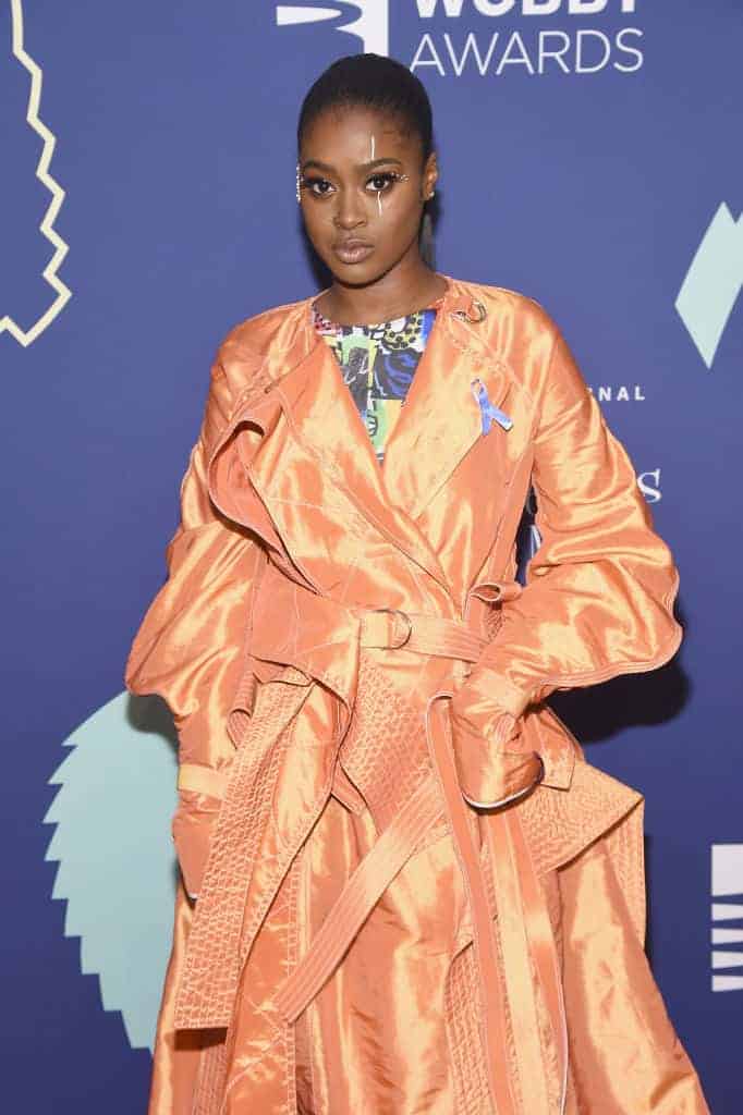 Tierra Whack wearing an orange outfit