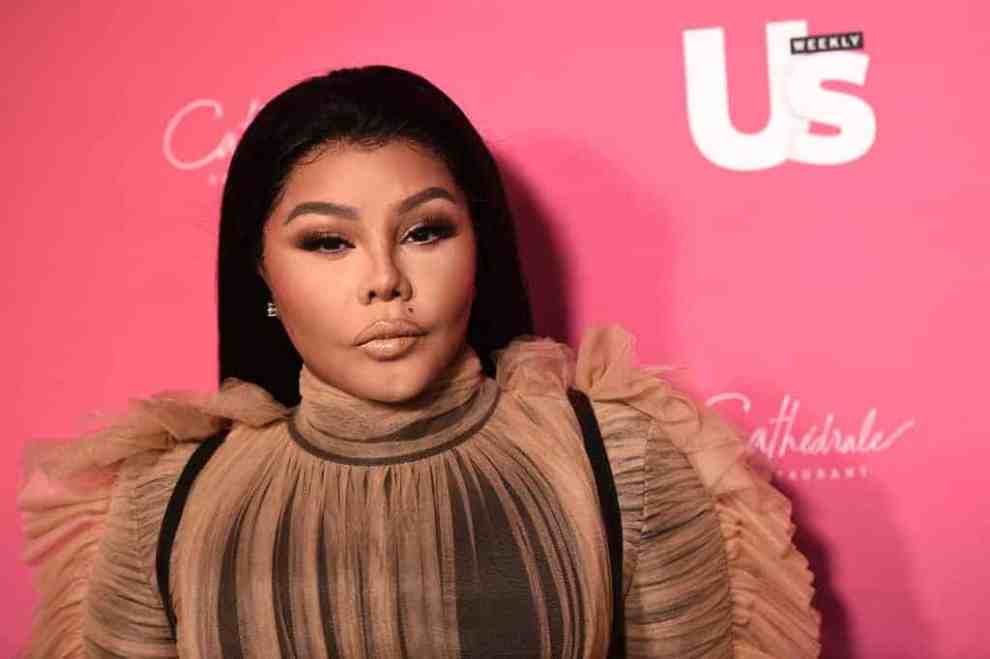 Lil Kim wearing tan and black