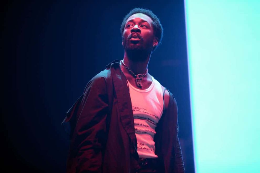 GoldLink on stage wearing black and white
