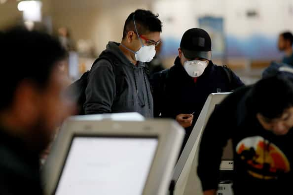 A passenger checks in for an American Airlines in Terminal D at Dallas/Fort Worth International Airport (DFW) on March 13