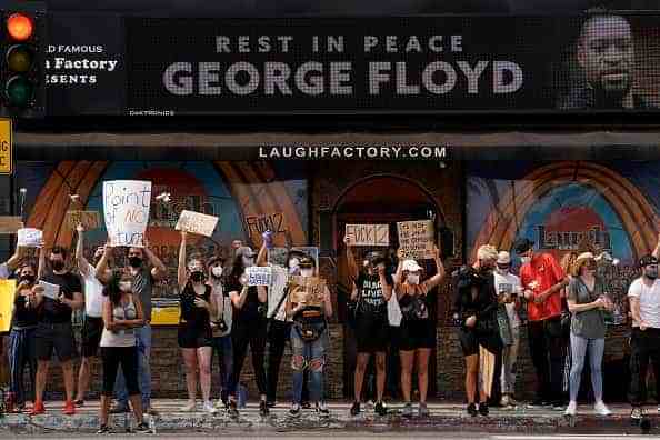 People demonstrate outside a comedy lounge on Sunset Blvd
