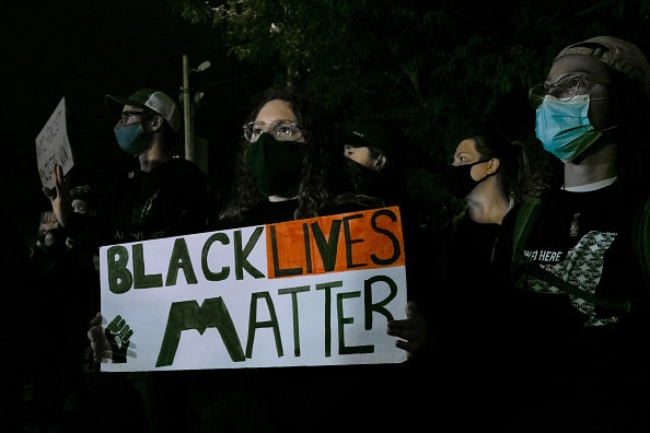 Demonstrators gather in front of the public safety building in protest of the police killing of Daniel Prude on September 8