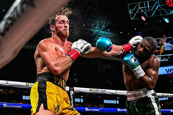 Former world welterweight king Floyd Mayweather (R) and YouTube personality Logan Paul (L) fight in an eight-round exhibition bout at Hard Rock Stadium in Miami