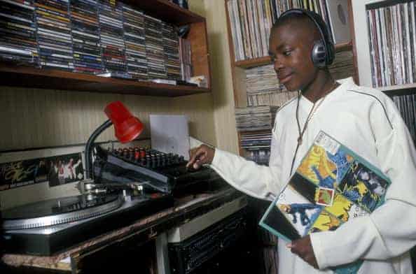 14 year old boy listening to music in his bedroom