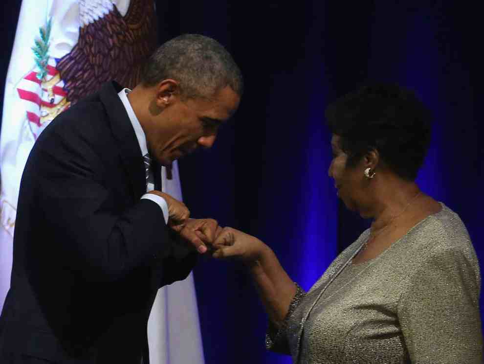 Aretha Franklin with President Obama giving a fist bump