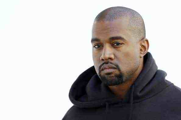 American rapper Kanye West poses before Christian Dior 2015-2016 fall/winter ready-to-wear collection fashion show on March 6
