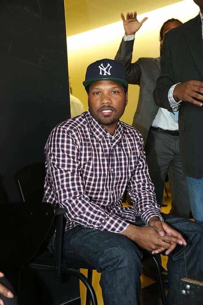 Mendeecees wearing a plaid shirt