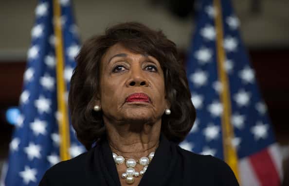 maxine waters in front of american flags