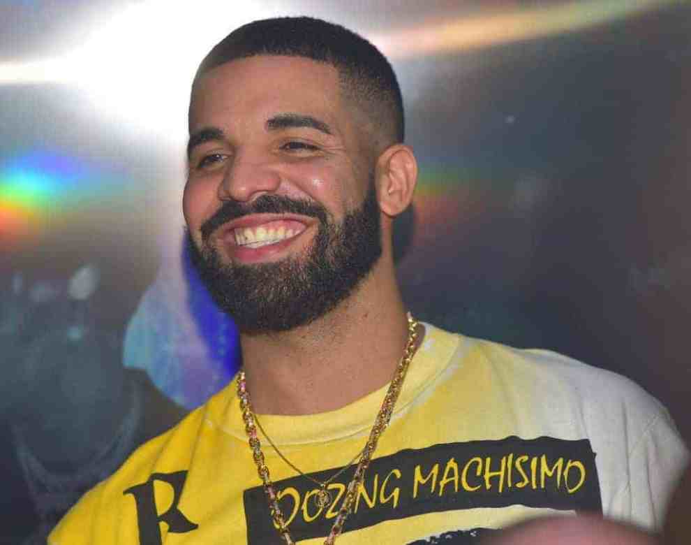 Drake Smiling wearing a Yellow