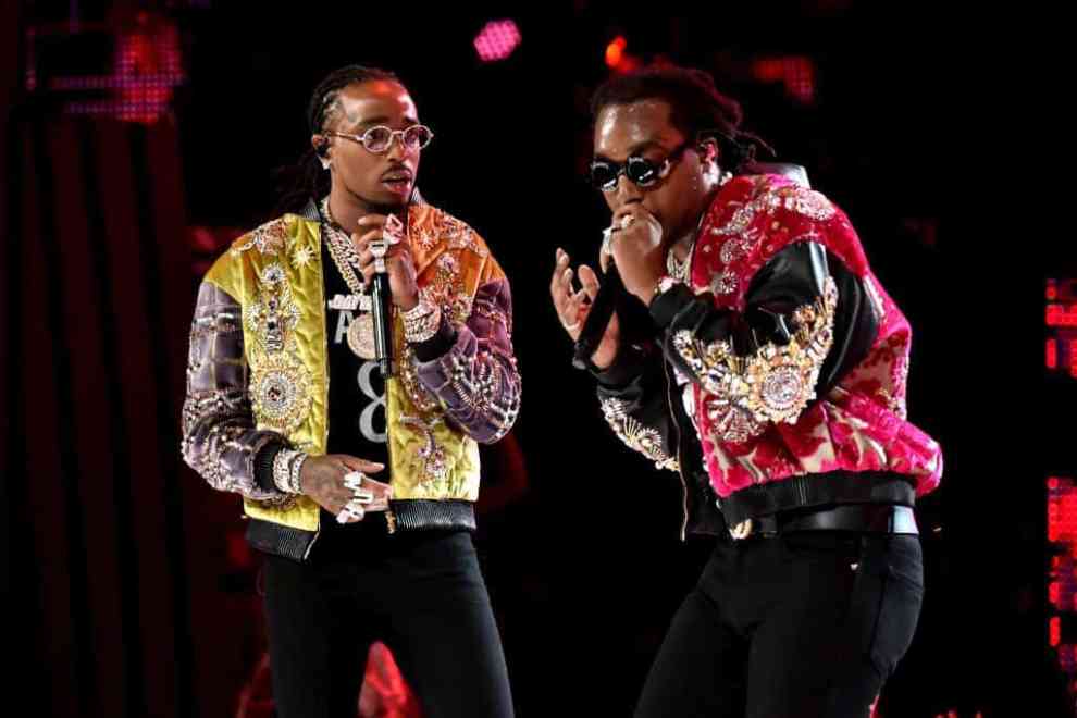 Takeoff and Quavo on stage wearing yellow and red jackets